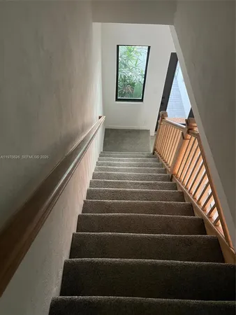 a bed sitting in a room next to a window