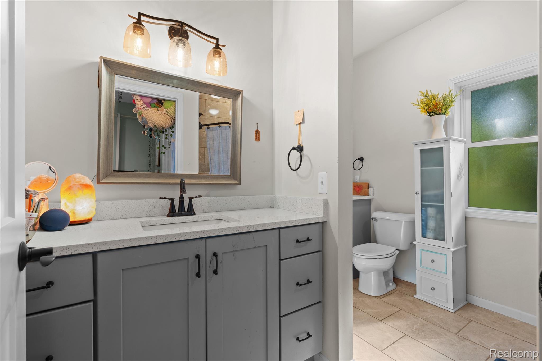 8306 Foster Road Clarkston, MI 48346 - Photo 21 of 38 Bathroom featuring vanity and a shower with shower curtain