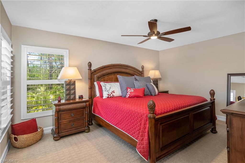 867 Carrick Bend Circle, Unit 2103 Naples, FL 34110 - Photo 21 of 32 a bedroom with a bed and a window
