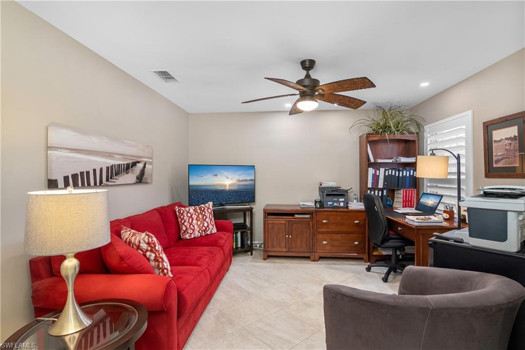 867 Carrick Bend Circle, Unit 2103 Naples, FL 34110 - Photo 22 of 32 a living room with furniture and a flat screen tv