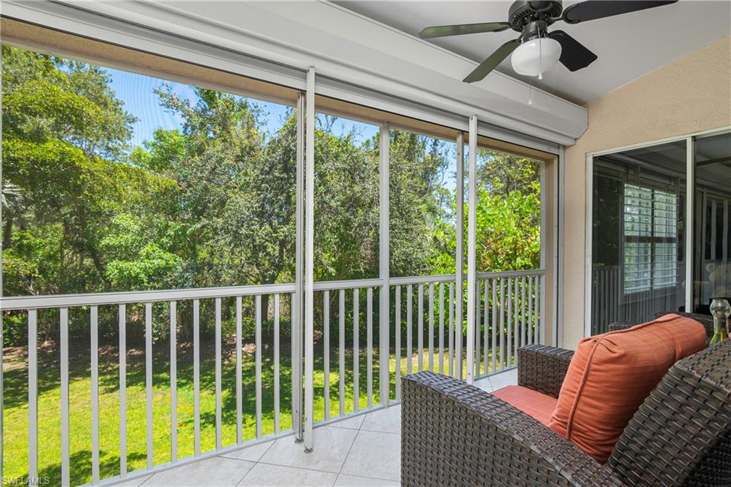 867 Carrick Bend Circle, Unit 2103 Naples, FL 34110 - Photo 27 of 32 a living room filled with furniture and a large window