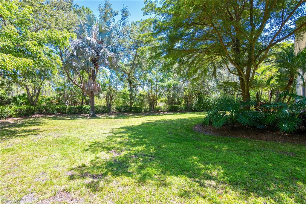 867 Carrick Bend Circle, Unit 2103 Naples, FL 34110 - Photo 28 of 32 a view of swimming pool with a yard