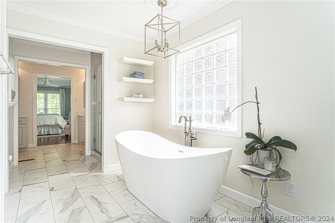 6860 Uppingham Road Fayetteville, NC 28306 - Photo 25 of 44 a white bath tub sitting next to a white sink