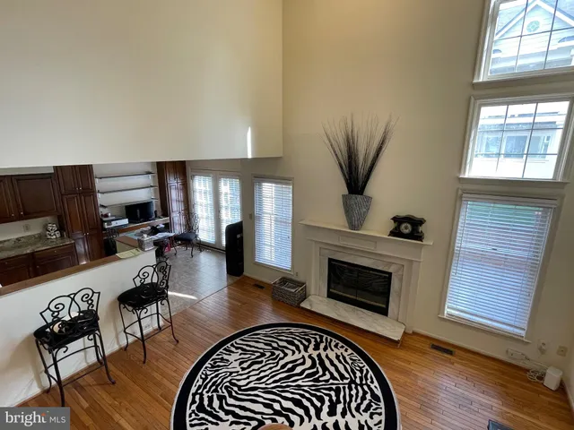 a view of a livingroom with a fireplace and a window
