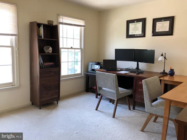 a bathroom with a sink a toilet a mirror and shower