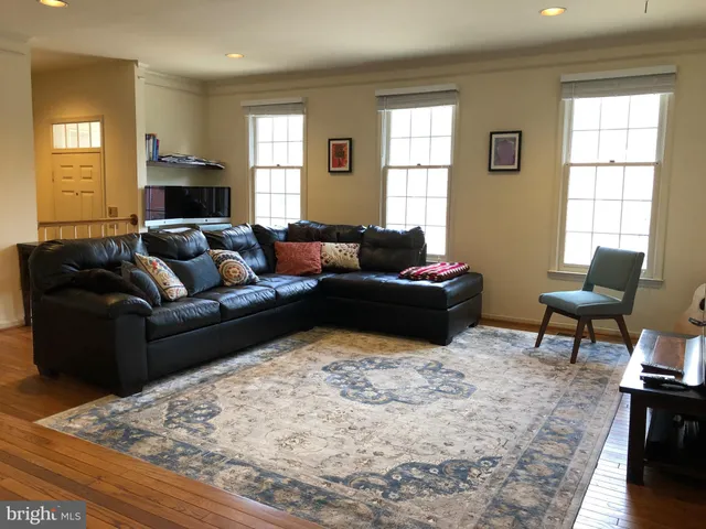 a living room with furniture window and wooden floor