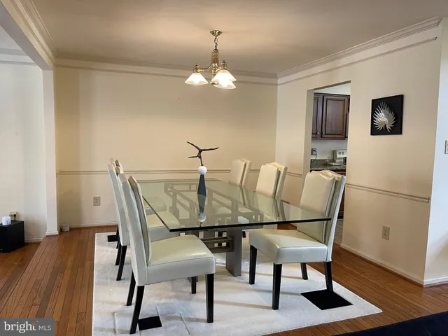a living room with furniture a fireplace and a chandelier