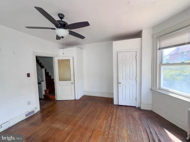 a view of a room with wooden floor and white walls