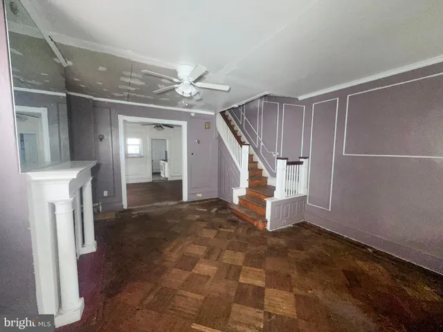 an empty room with windows and fireplace