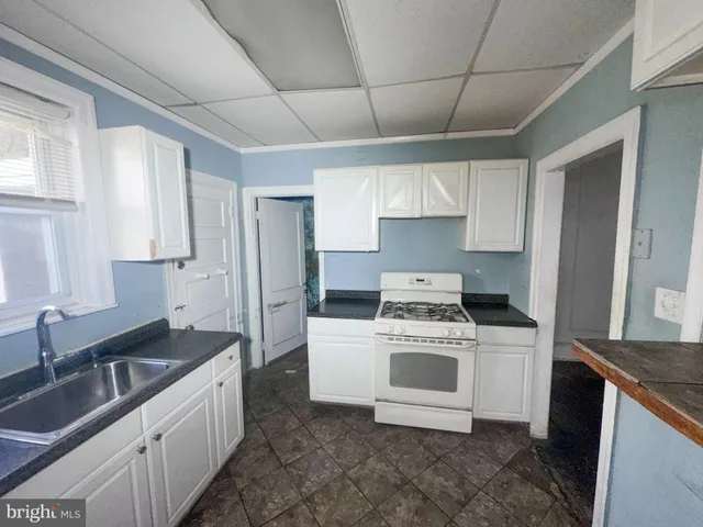 a kitchen with a sink stove and refrigerator