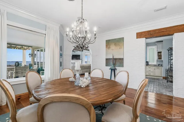 a kitchen with cabinets a sink and chairs in it
