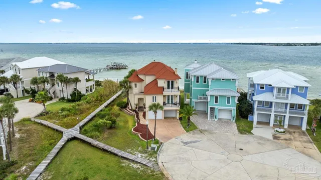 an aerial view of a house with a yard and sitting space