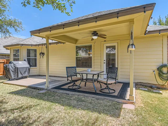 a view of a patio with a table and chairs
