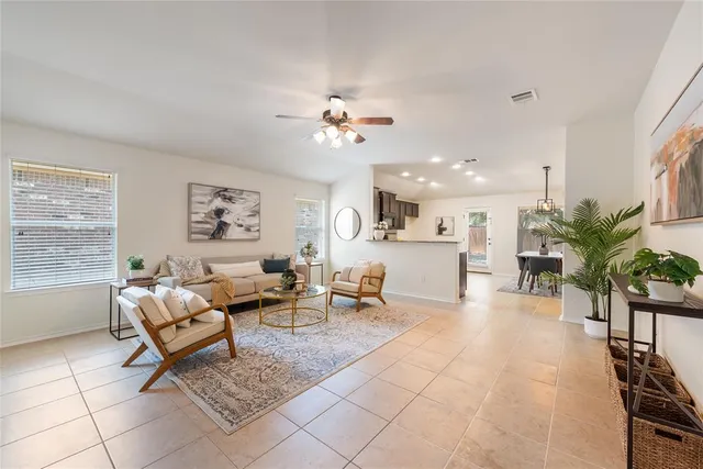 a living room with furniture flowerpot and window