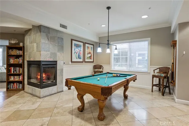 a living room with furniture a flat screen tv and a floor to ceiling window