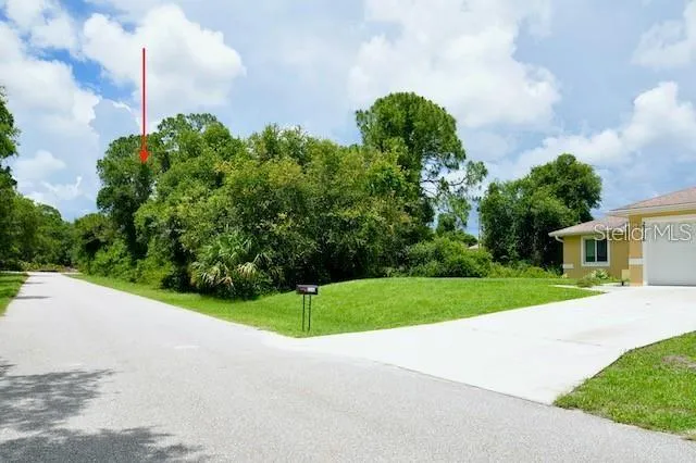 a view of a house with a yard and basketball court