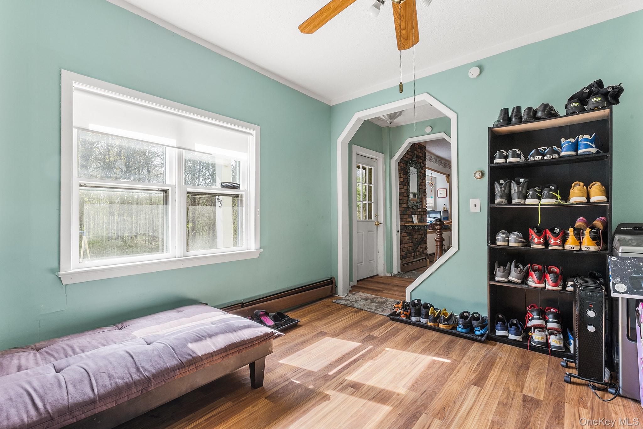 43 Taylor Road Parksville, NY 12768 - Photo 15 of 29 Bright interior space featuring wood-finish flooring, a ceiling fan, and a large window with white trim