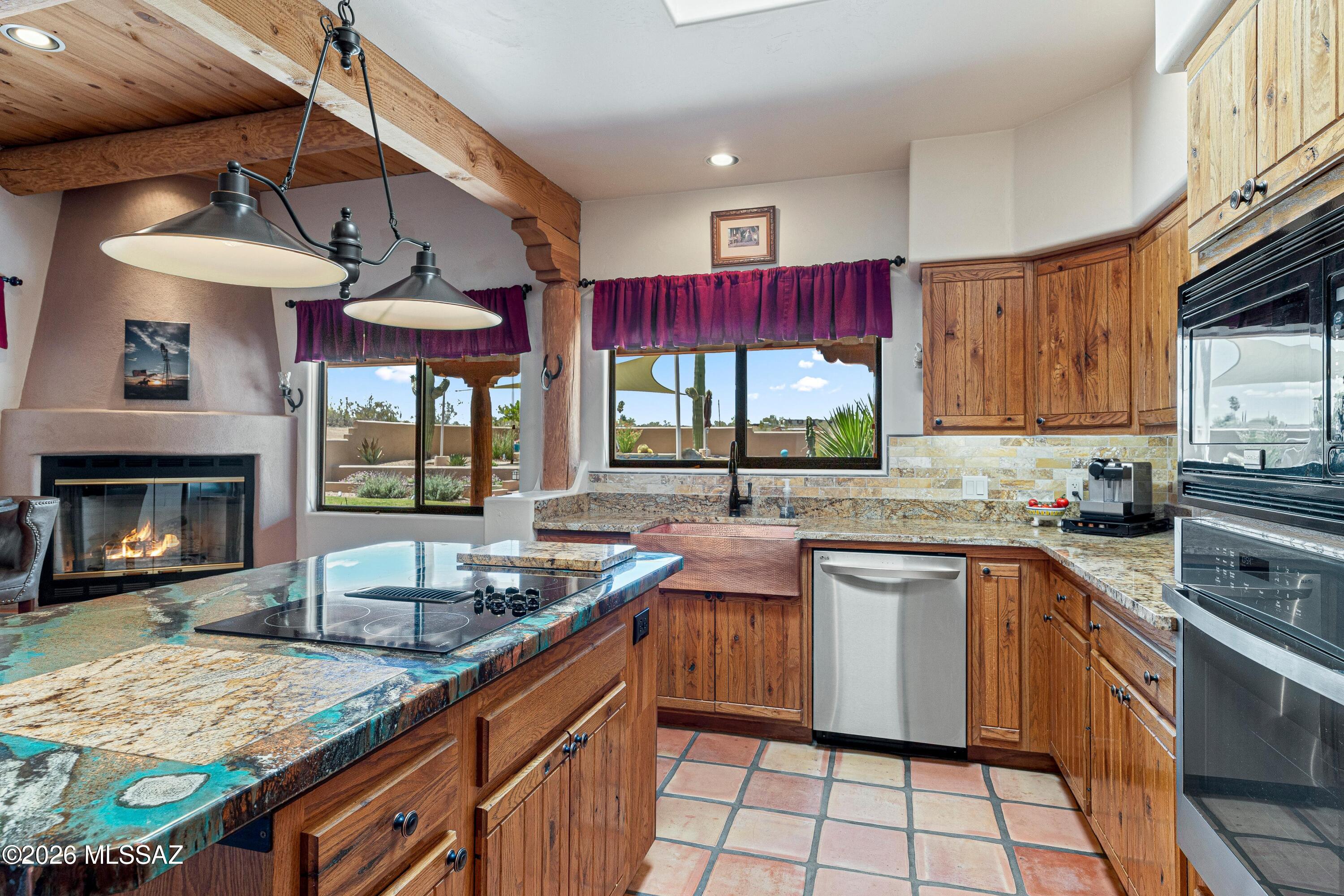 11160 East Golf Links Road Tucson, AZ 85730 - Photo 15 of 51 A mix of granite and acrylic counters, a copper sink and stainless appliances highlight this unique kitchen.