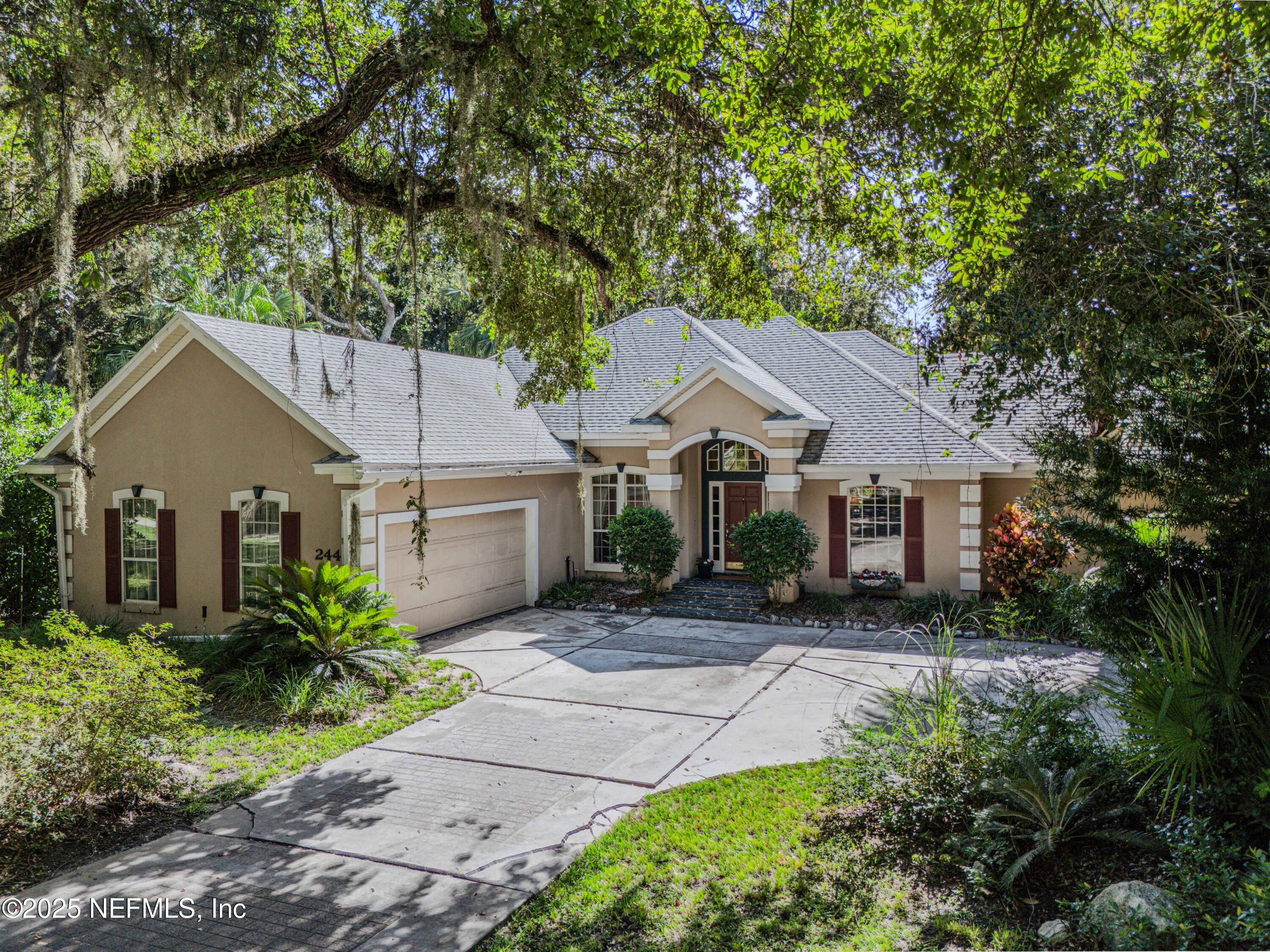 244 Bluebird Lane St. Augustine Beach, FL 32080 - Photo 1 of 66 a front view of house with yard and trees around