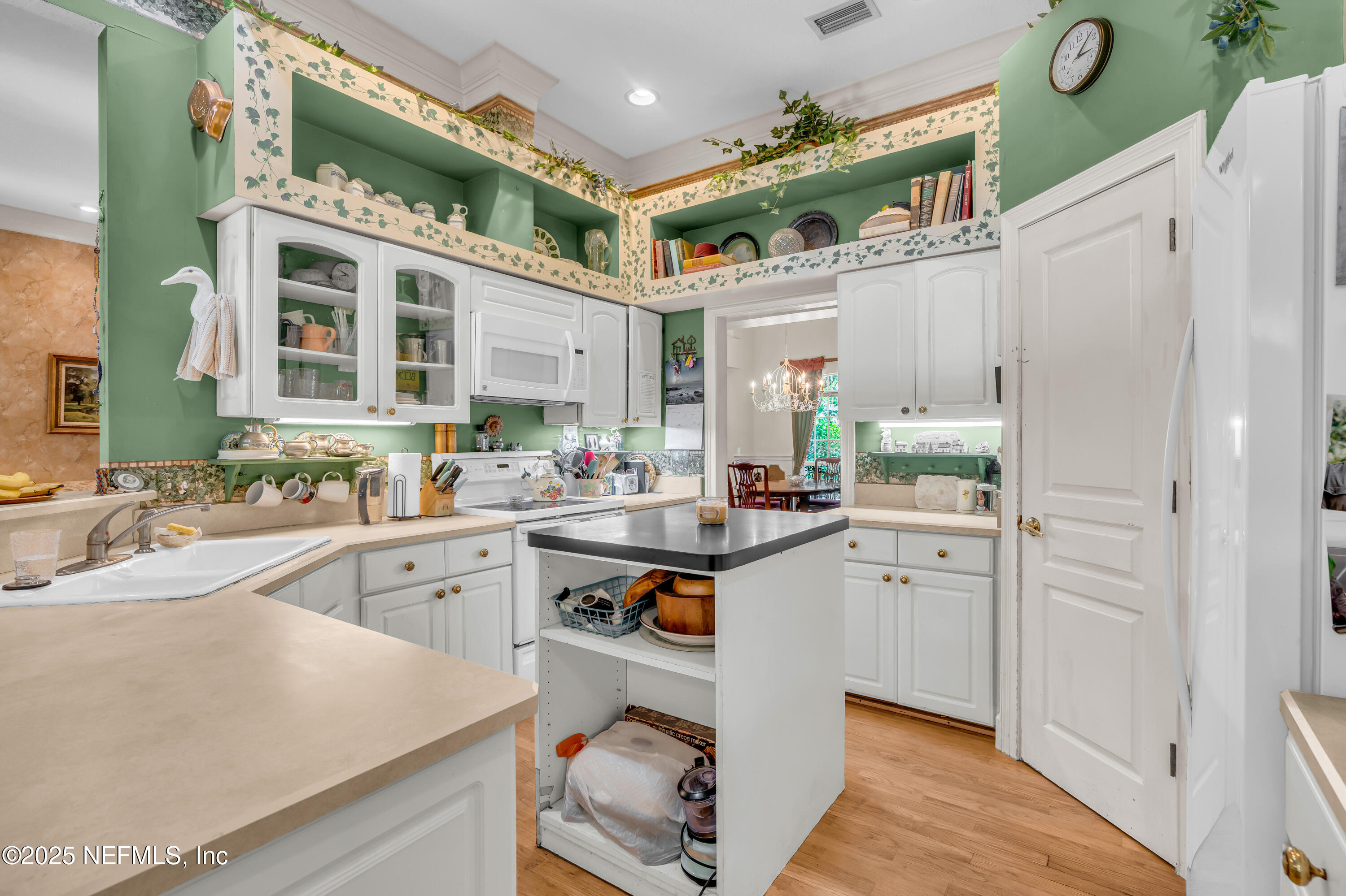 244 Bluebird Lane St. Augustine Beach, FL 32080 - Photo 17 of 66 a kitchen with cabinets and window