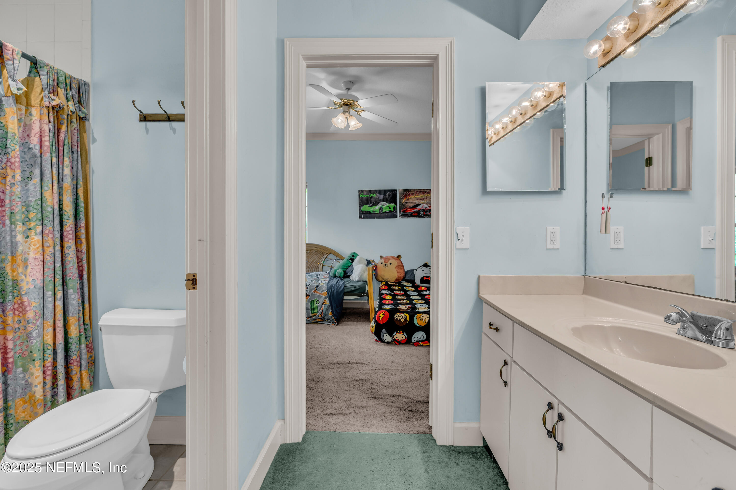 244 Bluebird Lane St. Augustine Beach, FL 32080 - Photo 40 of 66 a en suite bathroom with a toilet sink and mirror