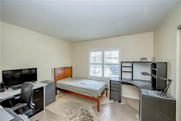 a bedroom with furniture and a window