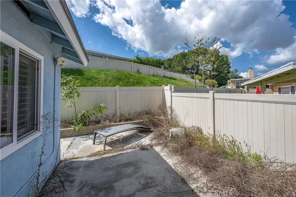 a view of backyard with plants and outdoor seating