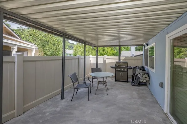 a view of a chairs and table in a patio