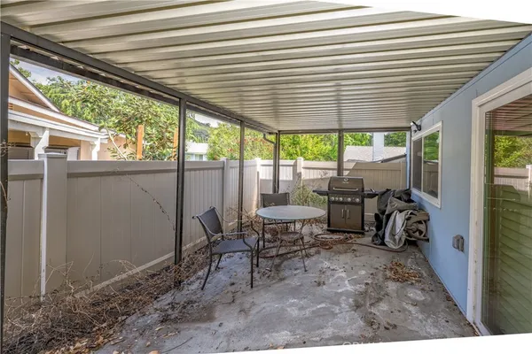 a view of a chairs and table in patio