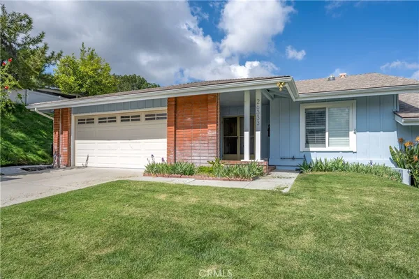 a view of a house with a yard and plants