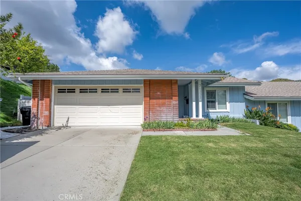 a front view of house with yard and green space