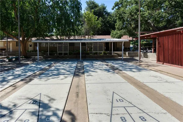a view of a house with backyard and sitting area