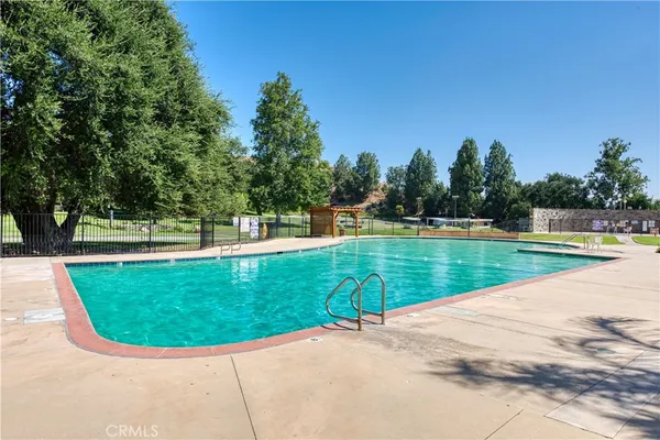 a view of a swimming pool with a yard