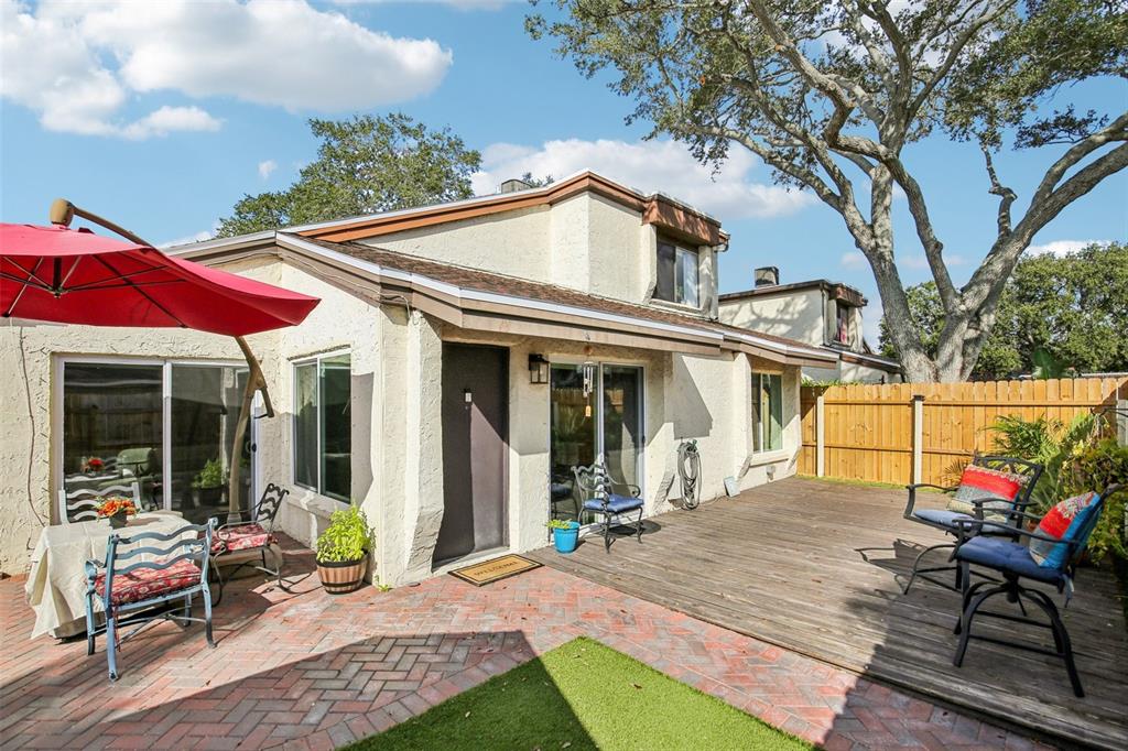 a view of a house with backyard porch and sitting area