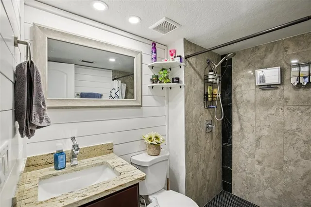a bathroom with a sink toilet and shower