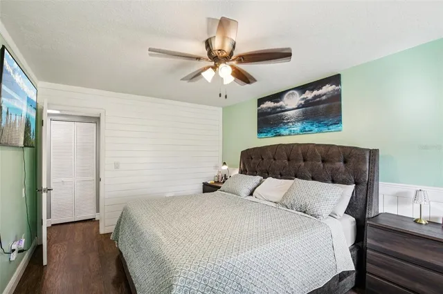 a bedroom with a bed and a chandelier