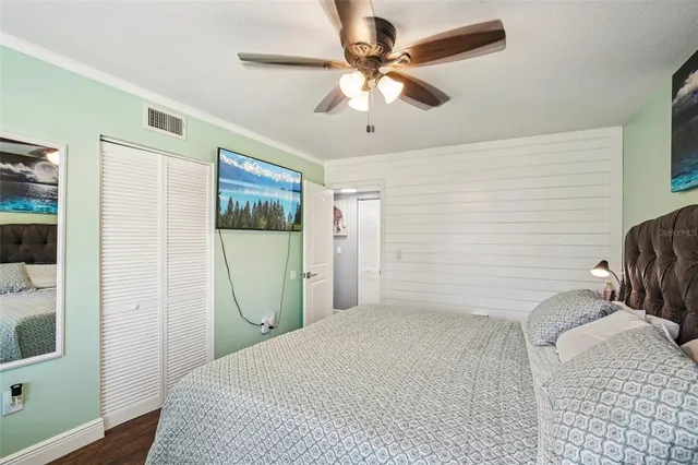 a bedroom with a bed and a mirror