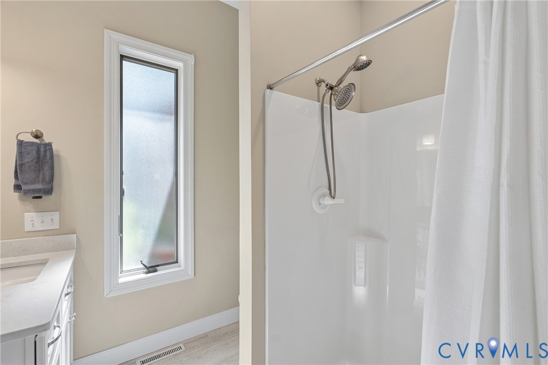 447 Tranquility Road Reedville, VA 22539 - Photo 40 of 82 Bathroom featuring a shower with a two-head fixtur