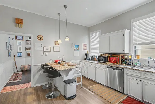 a kitchen that has a table and chairs in it