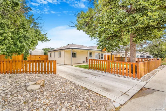 a view of a house with a wooden fence