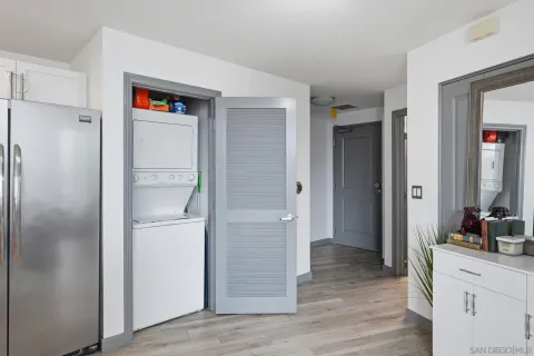 a bedroom with a bed tv and a window