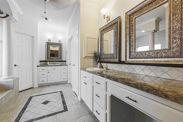 a spacious bathroom with a granite countertop sink mirror and