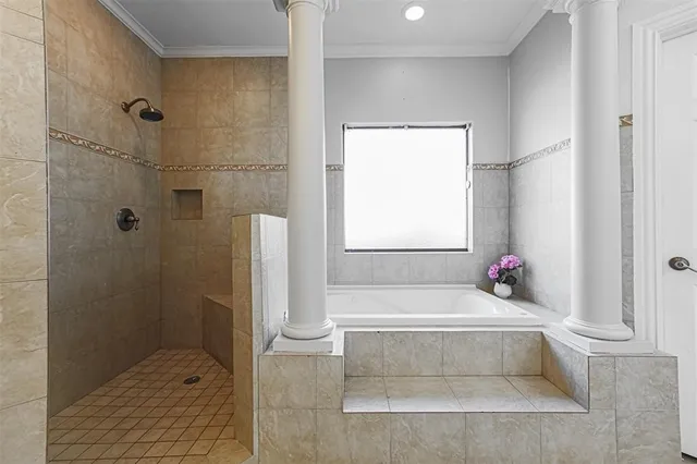 a bathroom with a tub shower and sink