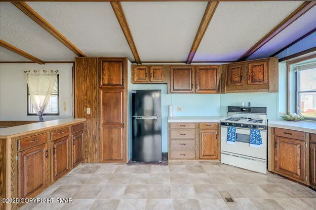 a kitchen with stainless steel appliances granite countertop a stove sink and cabinets