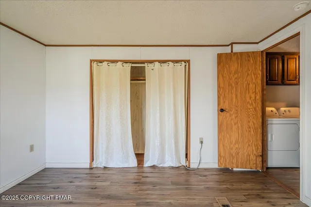 a view of a door and wooden floor in a room