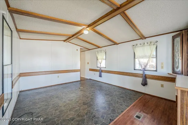 a view of an empty room with windows