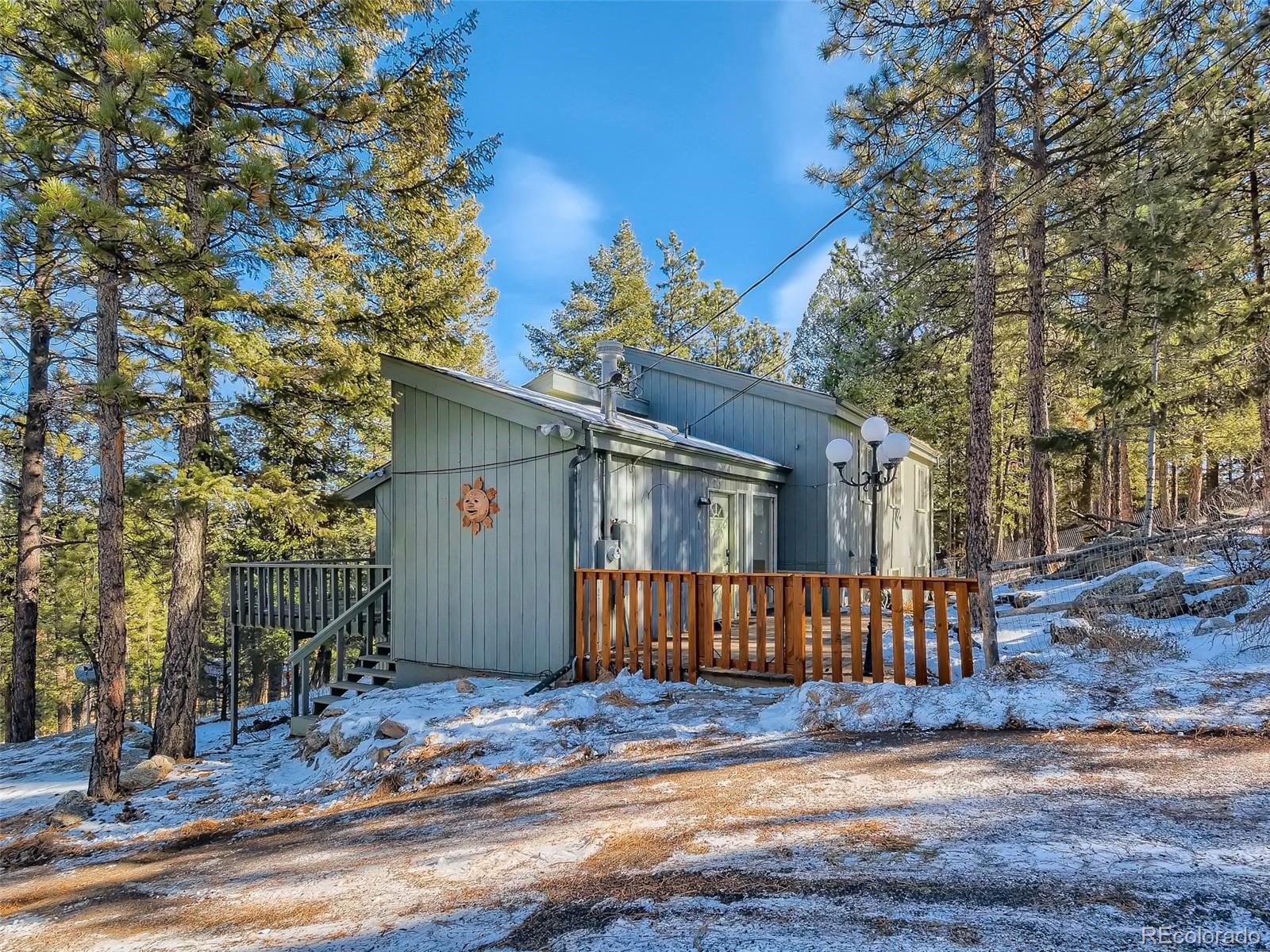 20 Long Ridge Drive Bailey, CO 80421 - Photo 1 of 25 a view of a house with wooden fence and large trees