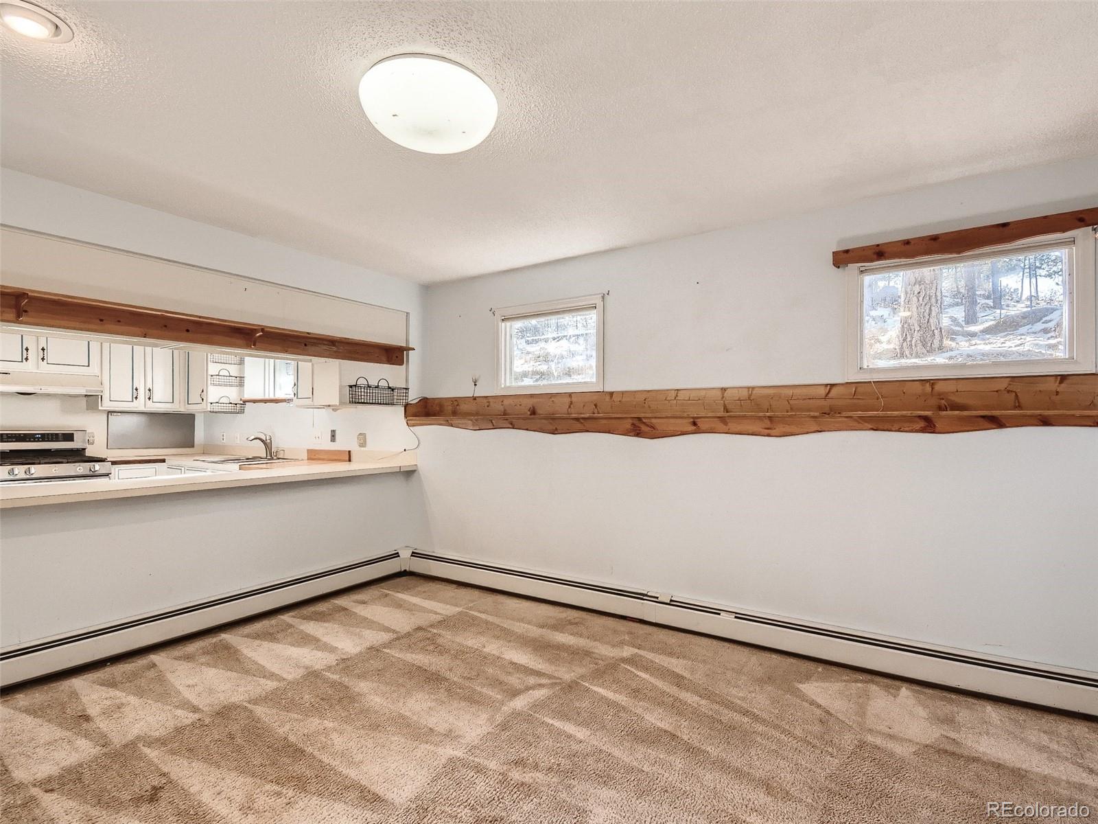 20 Long Ridge Drive Bailey, CO 80421 - Photo 16 of 25 a view of a kitchen with wooden floor and a window