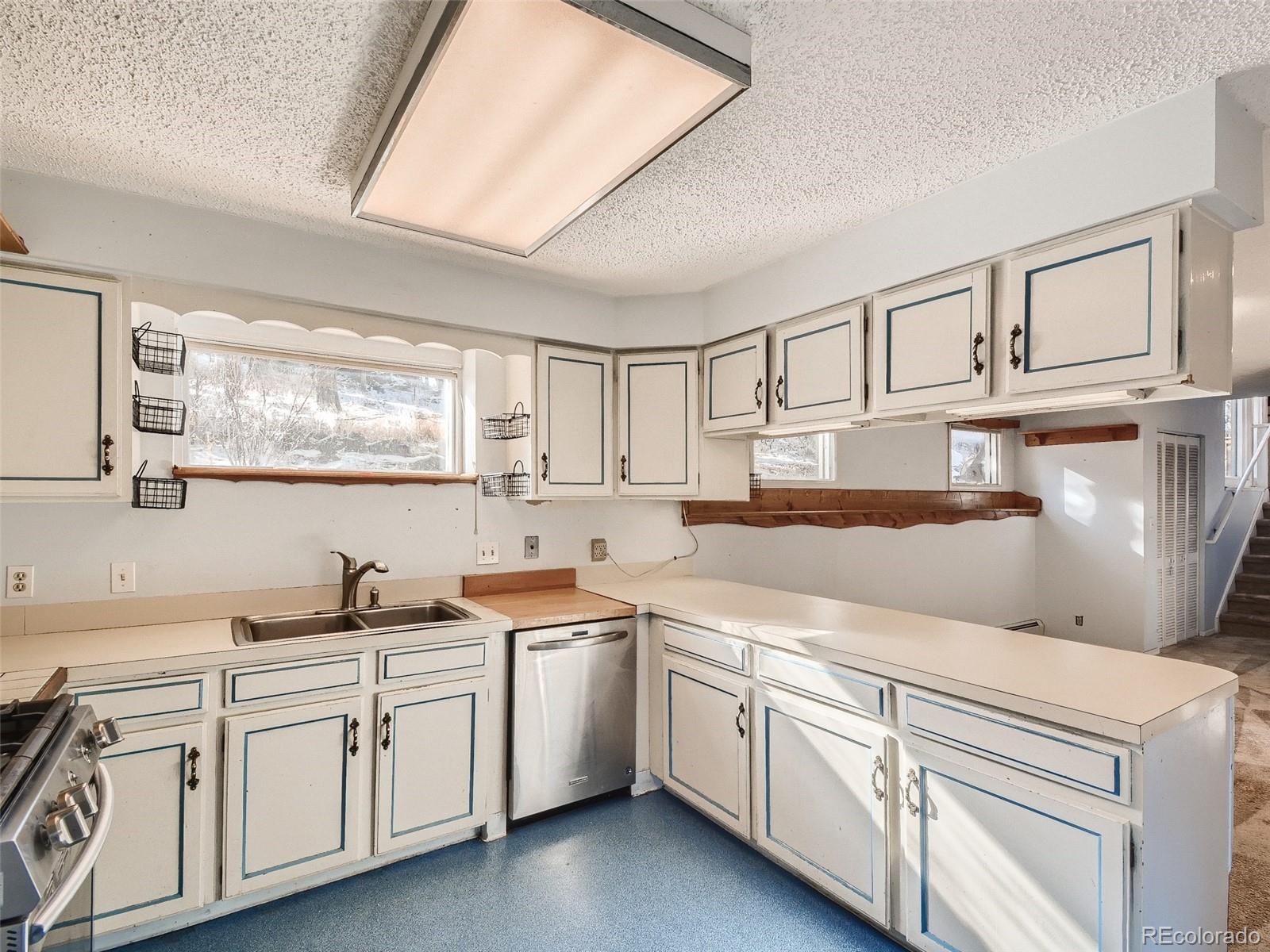20 Long Ridge Drive Bailey, CO 80421 - Photo 17 of 25 a kitchen with cabinets appliances a sink and a window