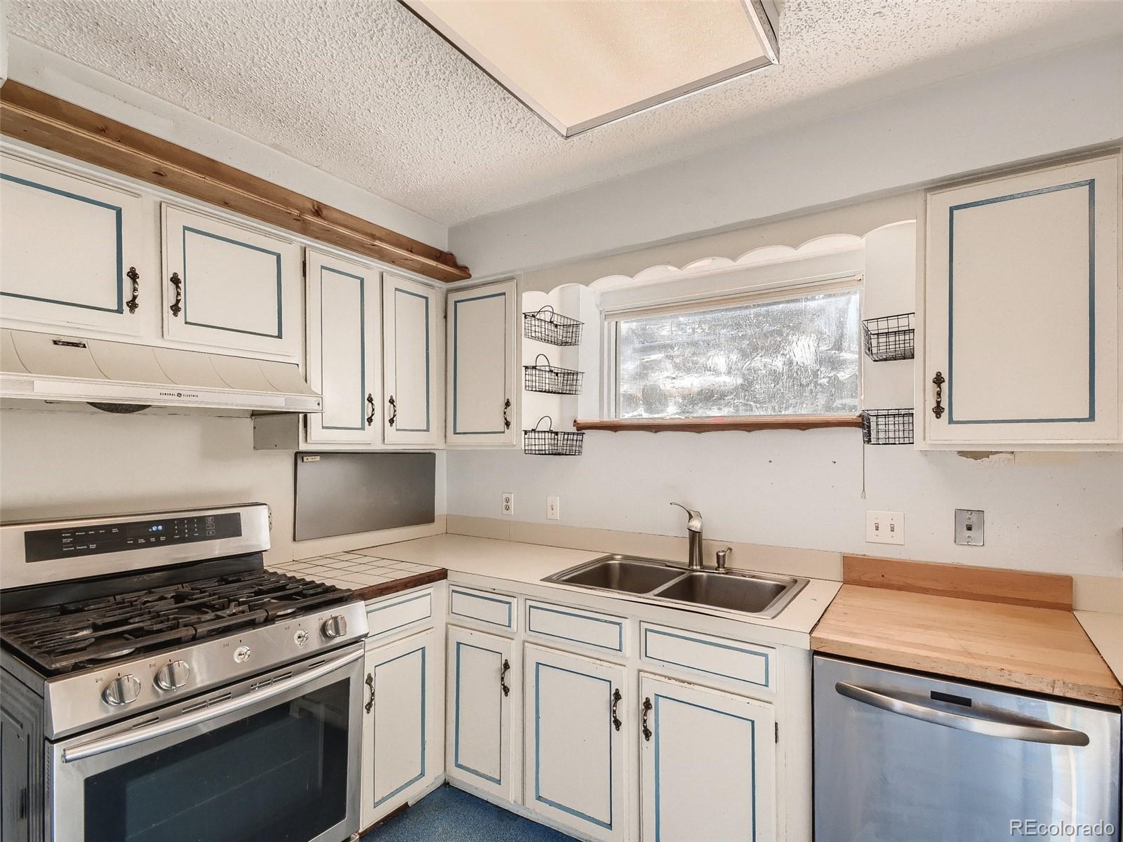 20 Long Ridge Drive Bailey, CO 80421 - Photo 18 of 25 a kitchen with white cabinets and appliances